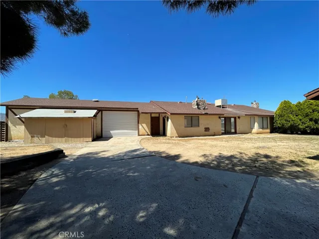 Back view of property and roll up garage door
