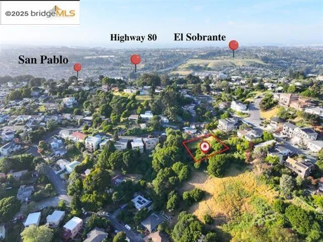 Aerial view of property's location featuring nearby suburban area
