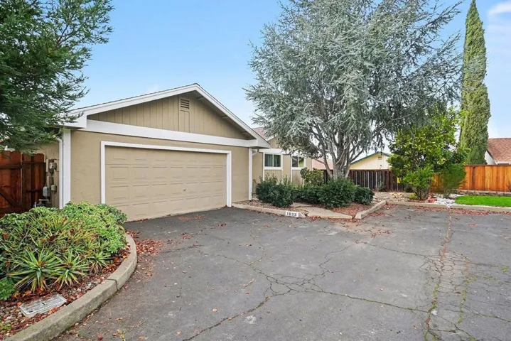 View of front of house with driveway and stucco siding