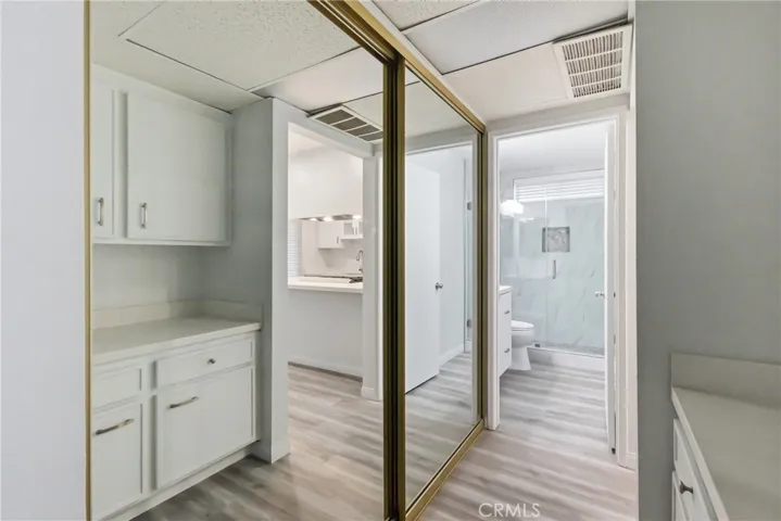 Spacious closet with mirrored sliding 
doors.