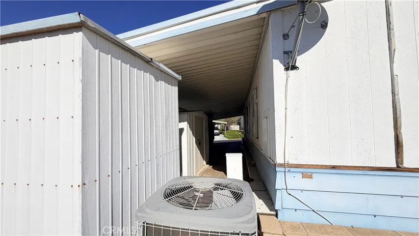Storage sheds in back of carport