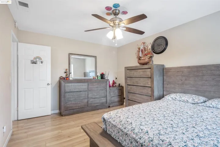 Bedroom with wood finished floors and a ceiling fan