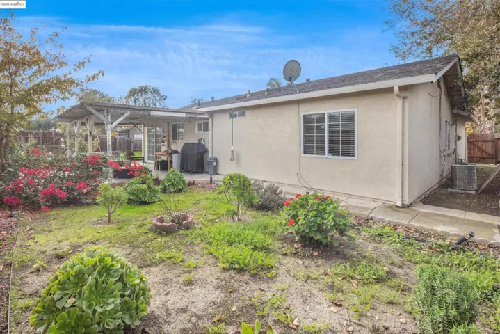 Rear view of property with a fenced backyard, stucco siding, and a patio