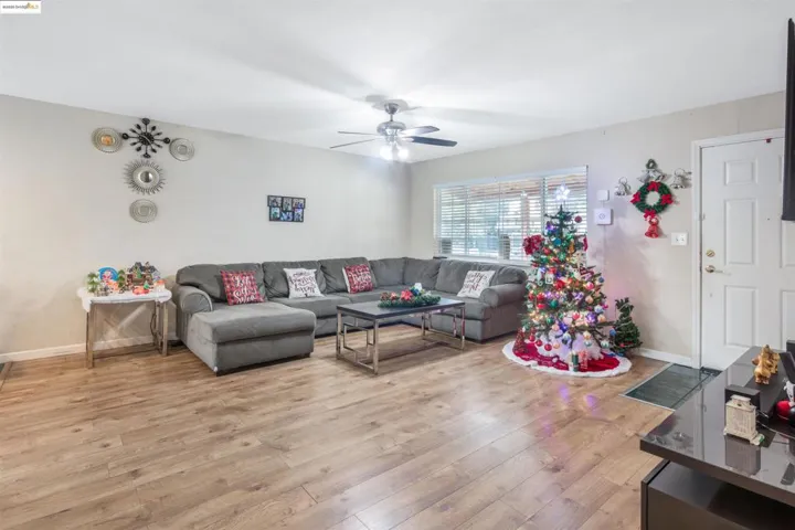 Living room featuring light wood-style flooring and a ceiling fan