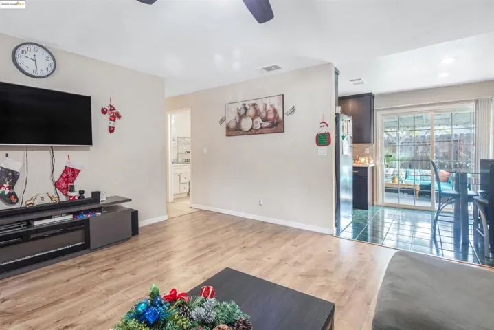 Living area featuring light wood-style floors and ceiling fan