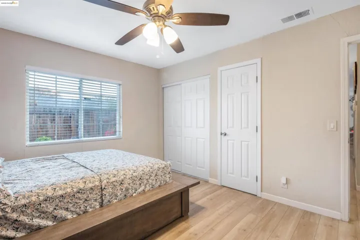 Bedroom featuring light wood-style flooring and a ceiling fan