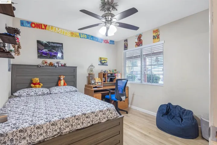 Bedroom with light wood-type flooring and a ceiling fan