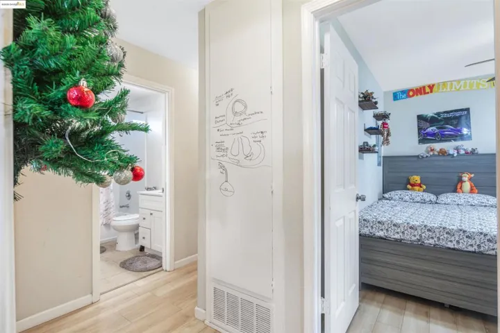 Hallway featuring light wood-style flooring and baseboards