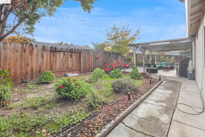 Fenced backyard with a patio and an outdoor living space