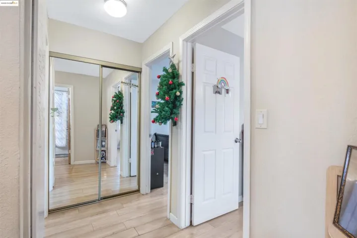 Entryway with light wood finished floors and baseboards
