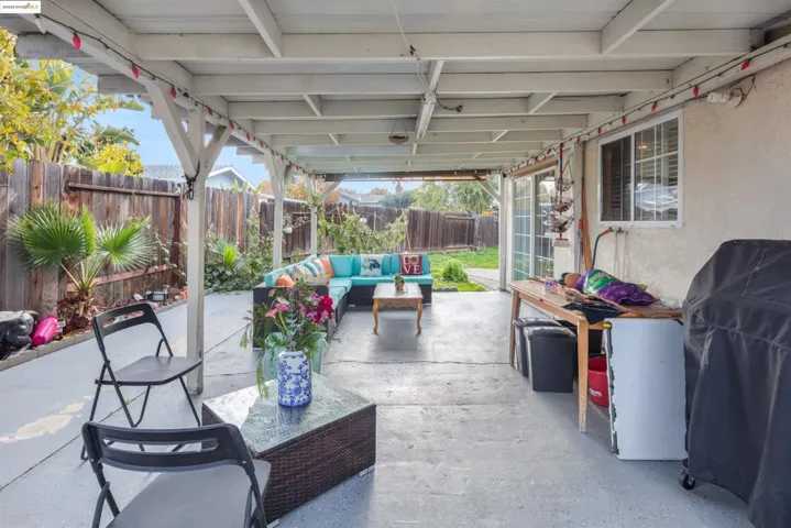 Fenced backyard with outdoor lounge area and a patio