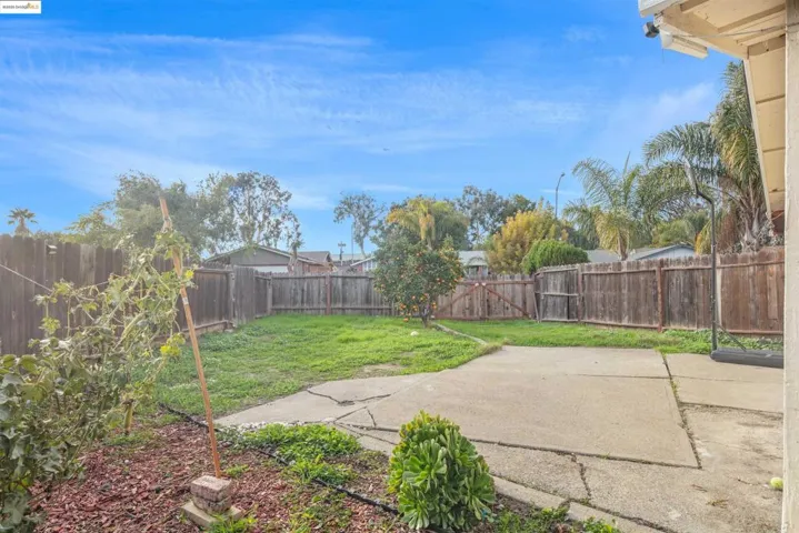 Fenced backyard featuring a patio