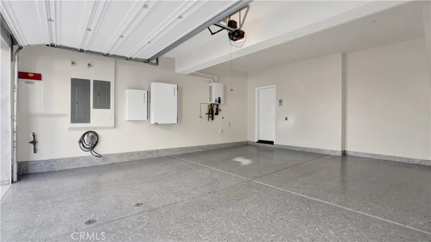 Epoxy floor finish in 2 car garage direct access to the house.  There are chargers already installed for your convenience and a tankless water heater.