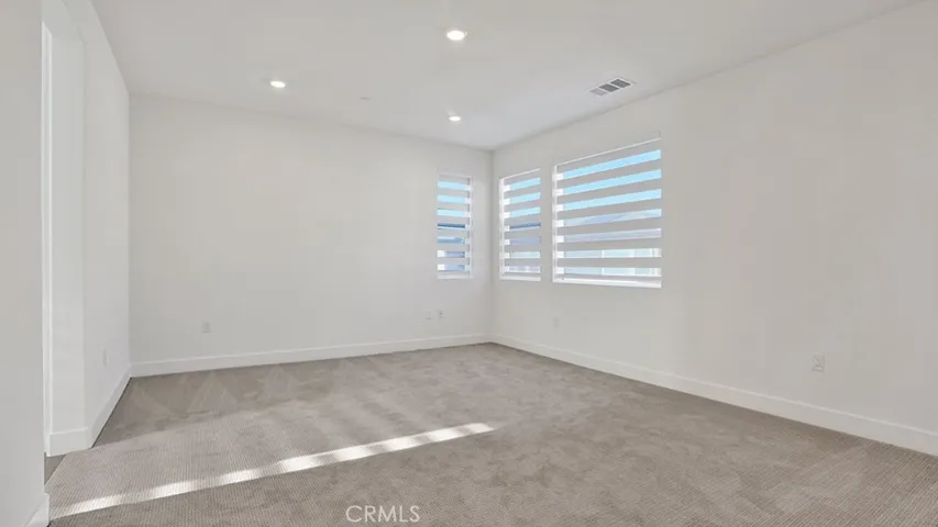 Very Large Master Suite with Custom window coverings, new carpet.  Notice opening to the left which leads to the Primary Bathroom.