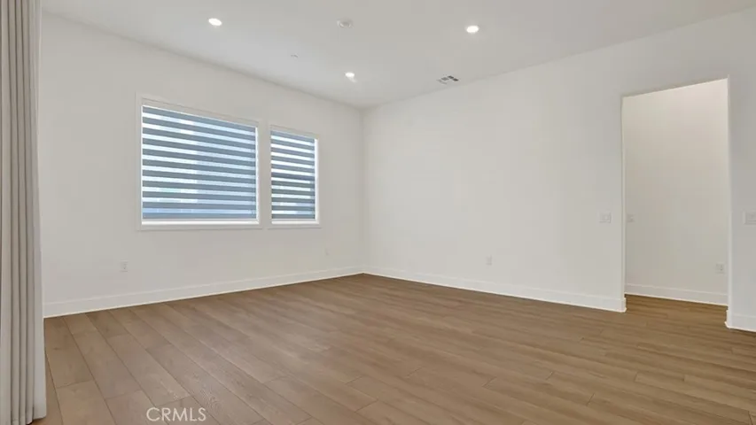 Living room with custom window coverings.