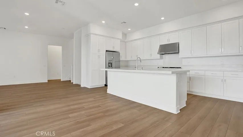 View from dining area.  High ceilings, beautiful flooring, Stainless steel appliances.  All of it...BRAND NEW.