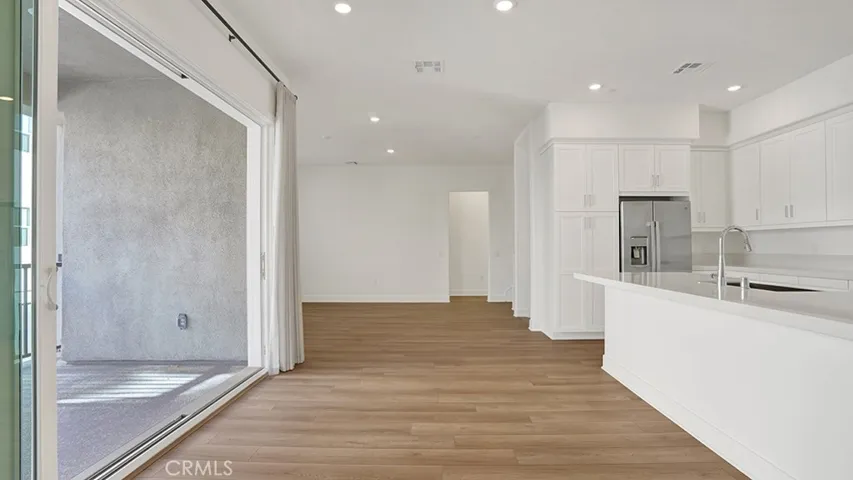 Amazing view in the dining area.  Kitchen to the right and completely open sliding doors to the patio.  Creating an indoor/outdoor California living space!  Living room just beyond the patio.  Notice door opening to the hallway in the back ground, leads to Bedroom and full bathroom.