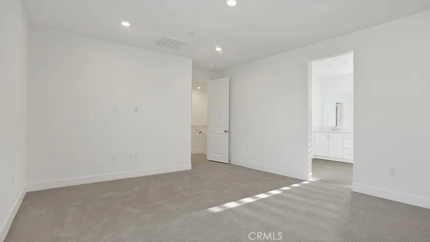 Primary Suite leading into Primary bathroom and Closet.  Notice the door adjacent to the staircase.