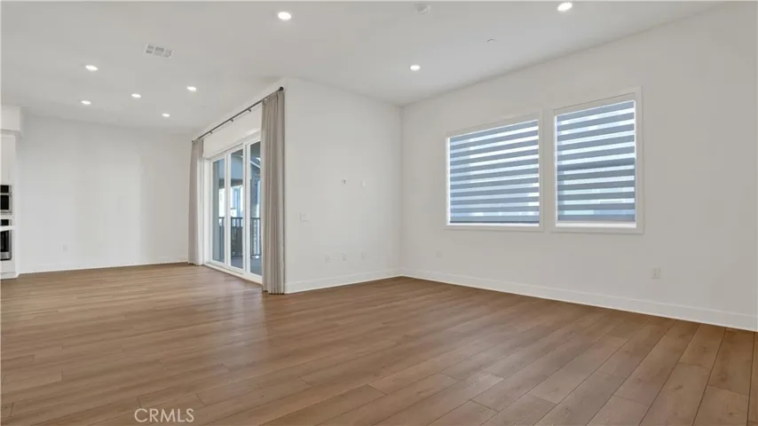 Living and Dining rooms.  The sliding door and windows carrys in warm natural lighting.