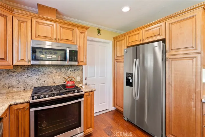 The kitchen boasts stainless steel appliances. Bonus, the refrigerator stays! The door leads to the attached 2-car garage.