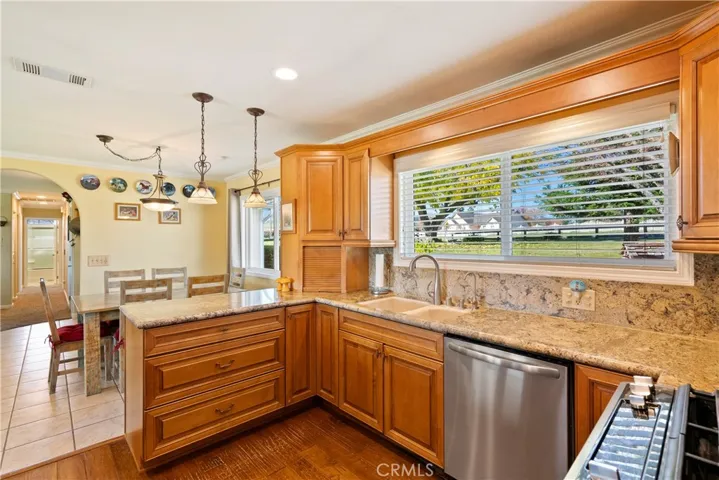 The granite countertops wrap the kitchen and offer plenty of space for preparing and serving meals.