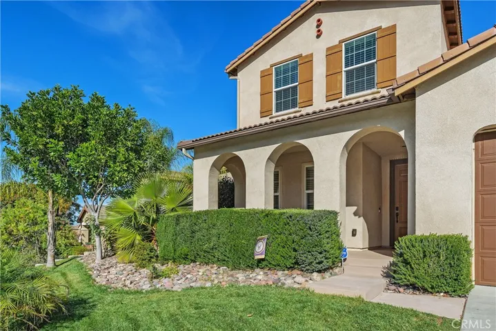 Landscaped front yard yard with hedges for privacy when you sit on the the covered porch.