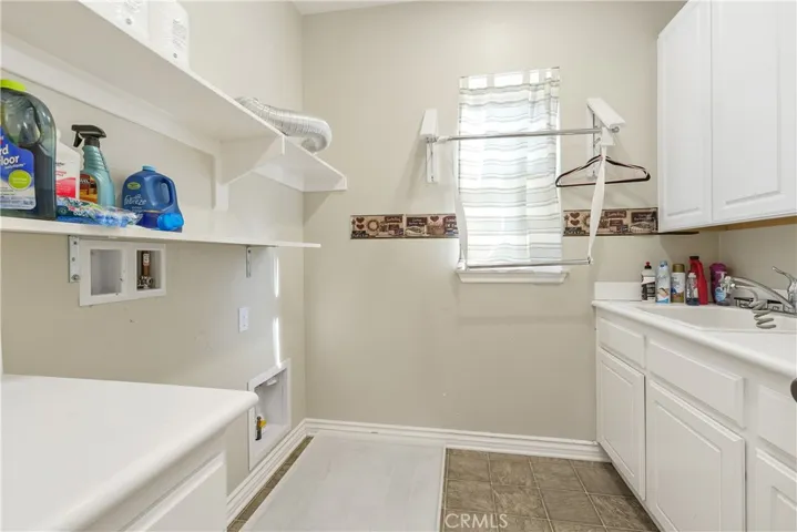 Laundry room with shelving and deep sink to wash your furbaby!