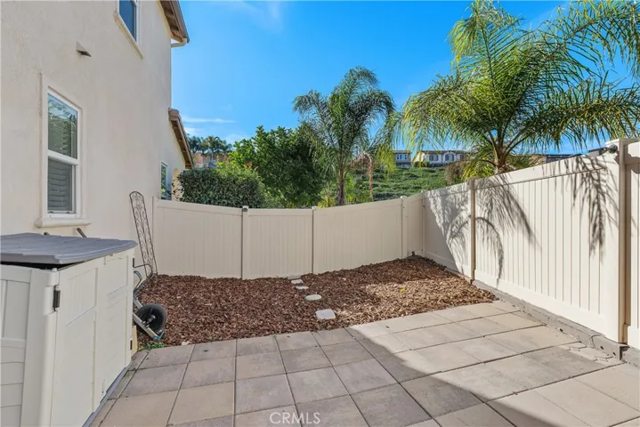 Generous side yard with mulch, pavers,2 sheds,( metal 10X10 not shown) is perfect spot for an outdoor spa or playset!