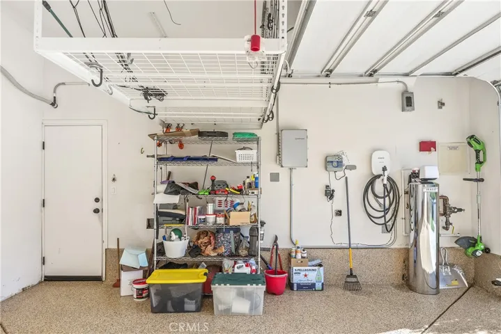 Another view of the garage showing the flooring,storage,Halo water system and EV charger.