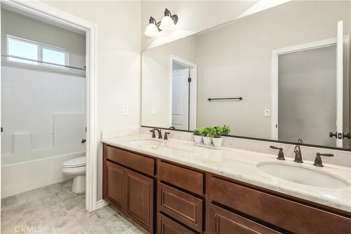 Hall bathroom upstairs with dual sinks.
