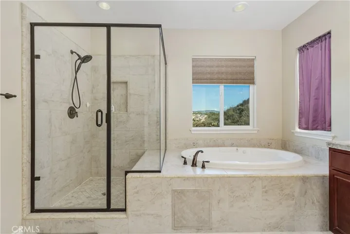 Large walk-in shower with bench seating and a jetted tub. Mountain views as you soak in the tub!