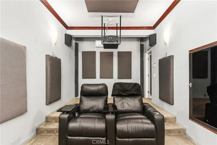 Another view of the theater room with crown molding