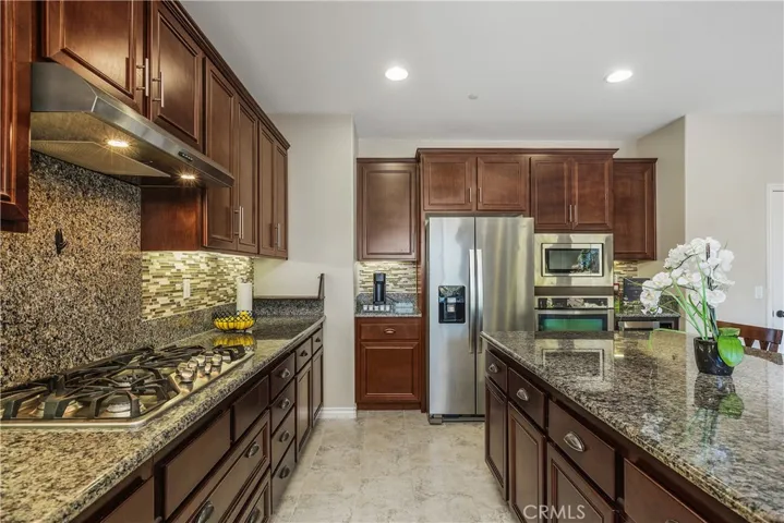 Hooded gas cook top, island storage, & coffee bar