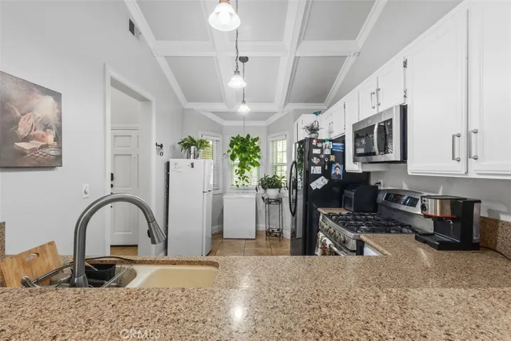 Sleek white cabinetry with new finishes and granite countertops.