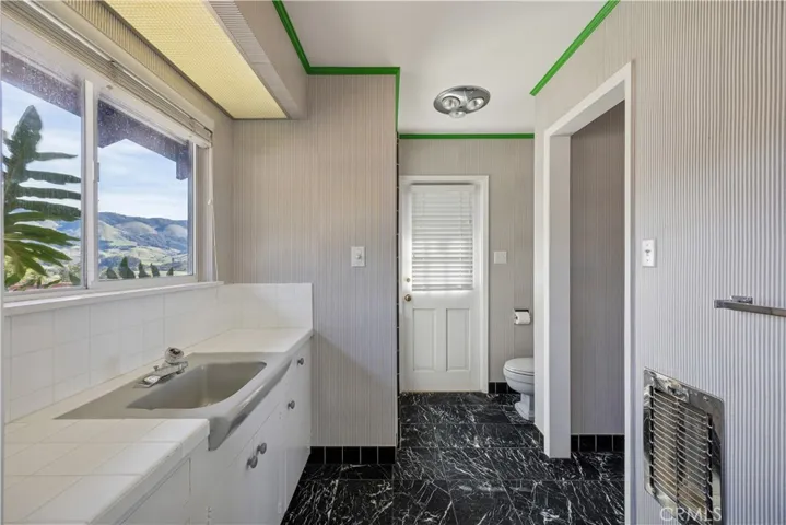 One of the bathrooms in the Primary suite with access to the patio and pool.
