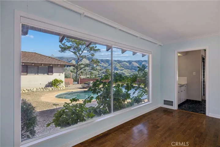 Primary suite with views of the patio and pool.