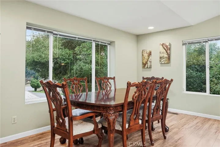 Large area by the windows is being used for dining area.