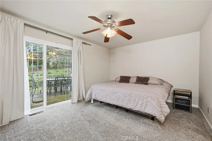 Primary bedroom has a sliding door to the back patio.