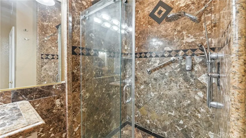 Spacious walk-in shower with glass enclosure
