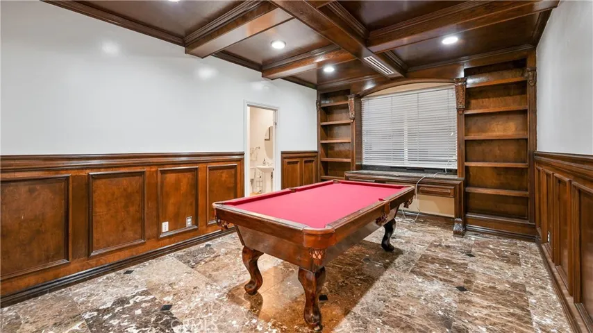 Spacious game room with wainscoting accents