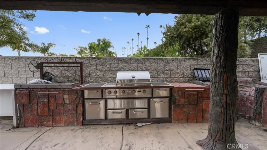 Outdoor kitchen with built-in grill and storage