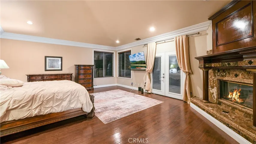 Spacious primary bedroom with balcony access