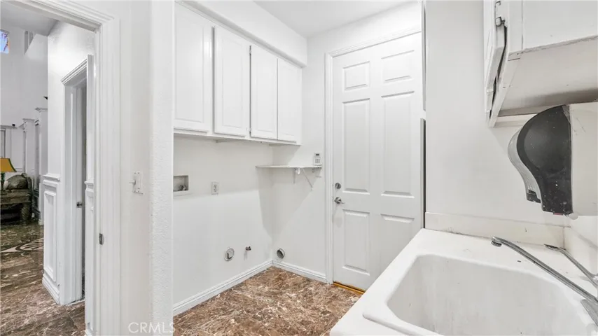 Large laundry room with counter and cabinet space