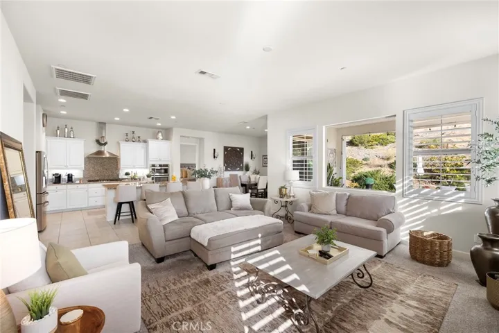 Open concept living room, looking into kitchen