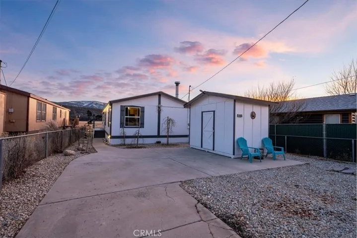 Front view of home and detached storage room