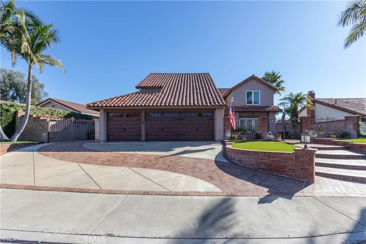 Three car garage, extra wide gated side yard, and an extra wide driveway as well, with a decorative swath of brick.