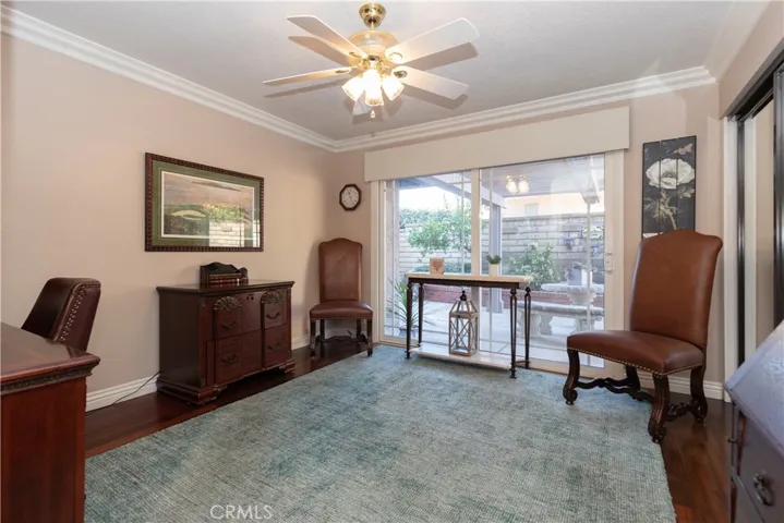 Main level office with a closet and slider to the side yard.