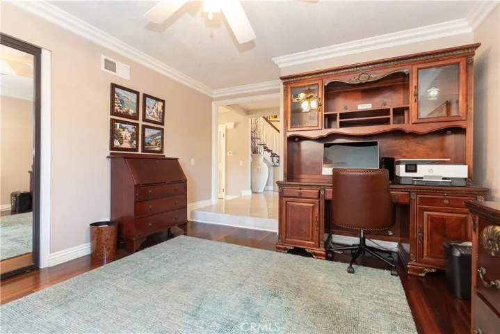 Wood floors and handsome woodwork in the office, just off the entry.
