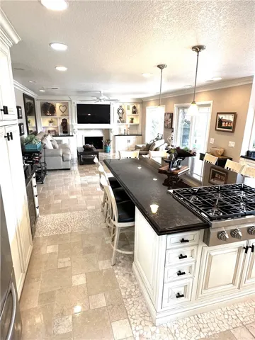 Gourmet kitchen center island seating 6+ opening into family room