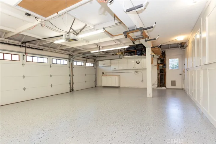 Sealed concrete floor in the garage, plus loads of cupboards.